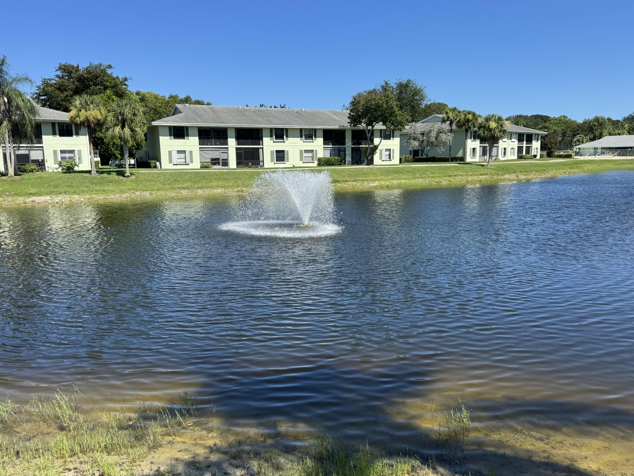 801 Sabal Ridge Circle, Unit H Palm Beach Gardens, FL 33418 - Photo 3 of 42 a view of a house with a yard