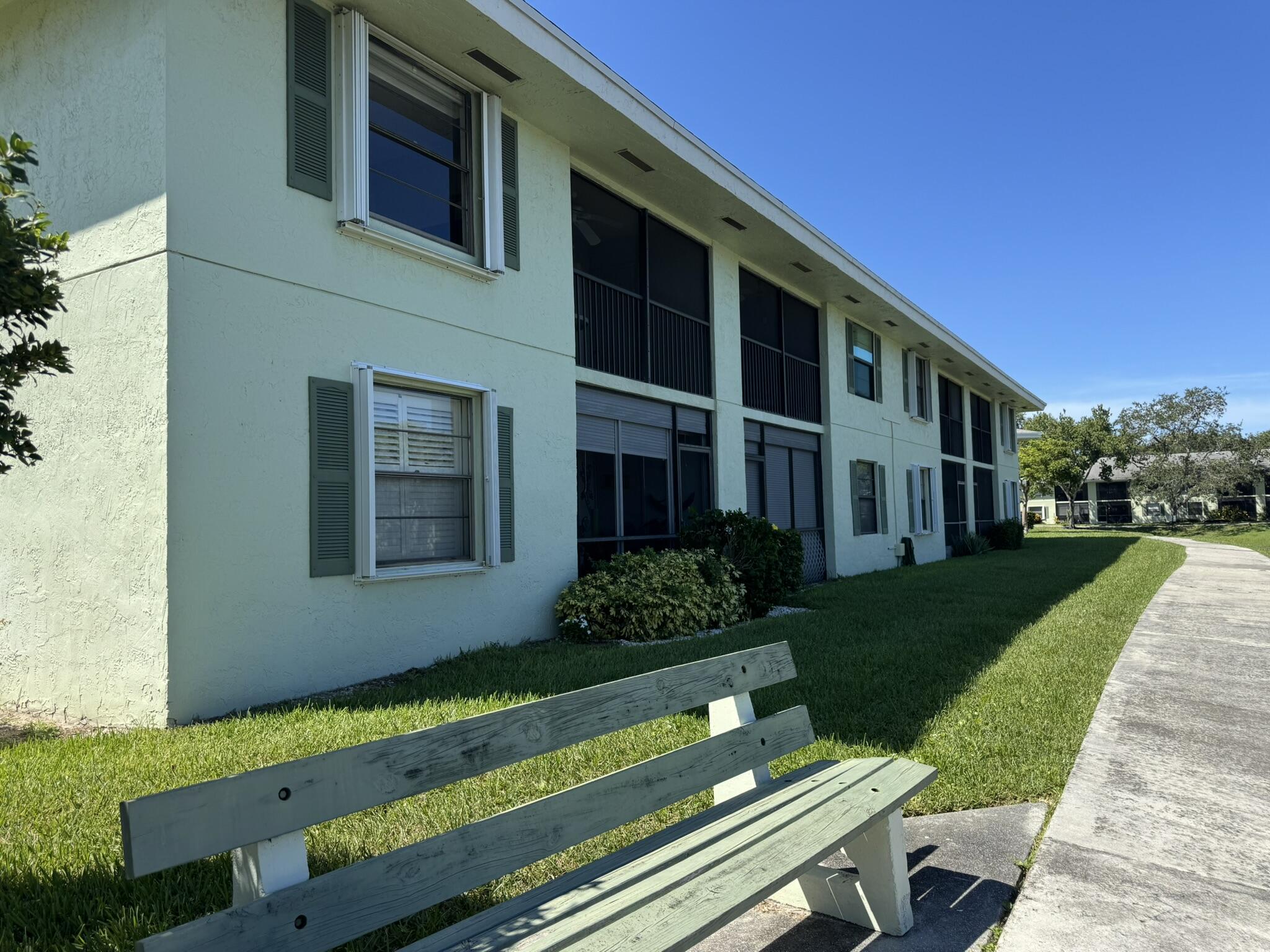 801 Sabal Ridge Circle, Unit H Palm Beach Gardens, FL 33418 - Photo 42 of 42 a front view of a house with a yard