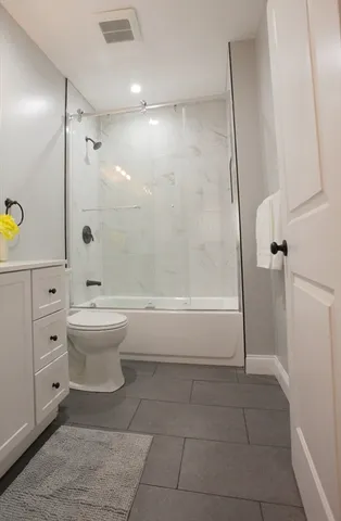 a bathroom with a toilet and a shower