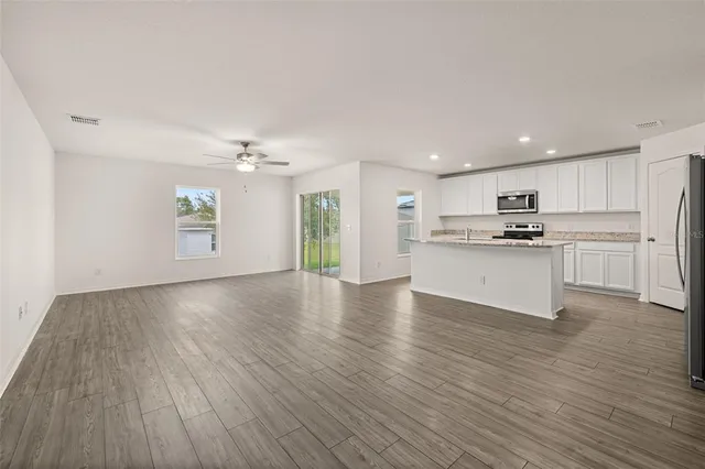 a kitchen with white cabinets appliances and sink