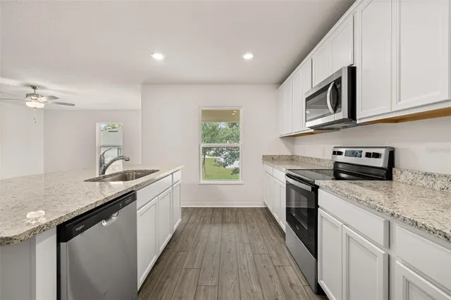 a kitchen with a sink stove and microwave