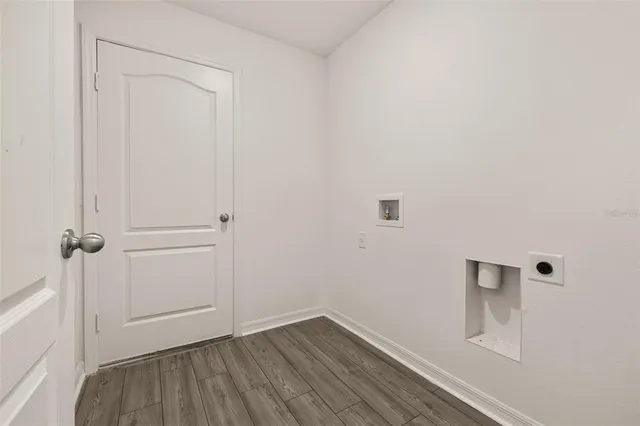 an aerial view of residential houses with outdoor space and parking