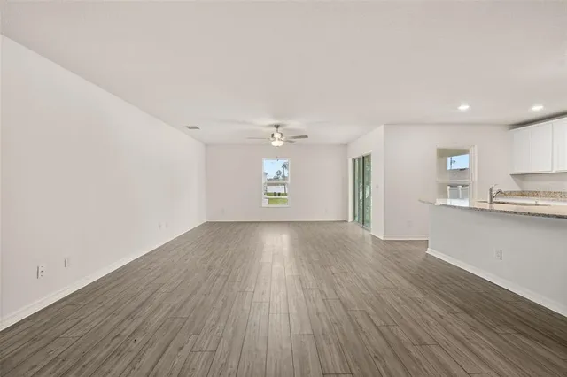 a view of kitchen with granite countertop stainless steel appliances refrigerator sink and cabinets