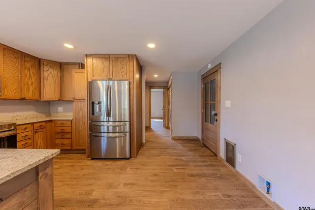 a kitchen with a refrigerator and a sink