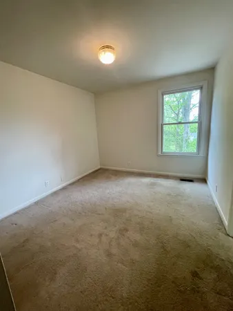 an empty room with a empty space and windows