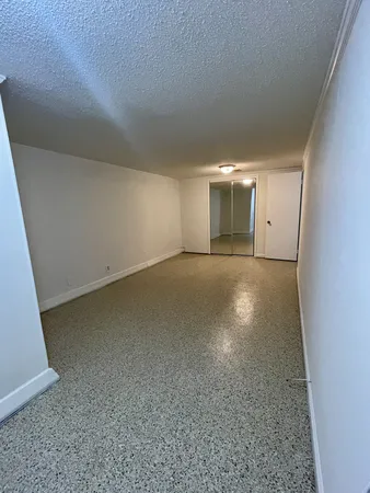 an empty room with a empty space and windows