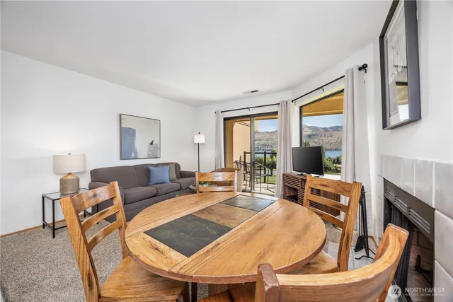 a living room with furniture a fireplace and a table