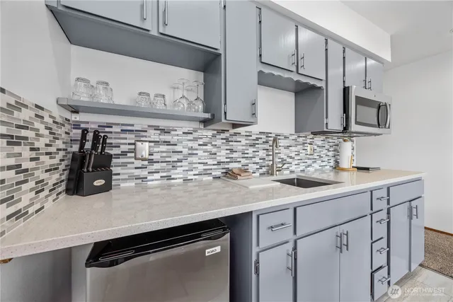 a kitchen with stainless steel appliances a sink and cabinets