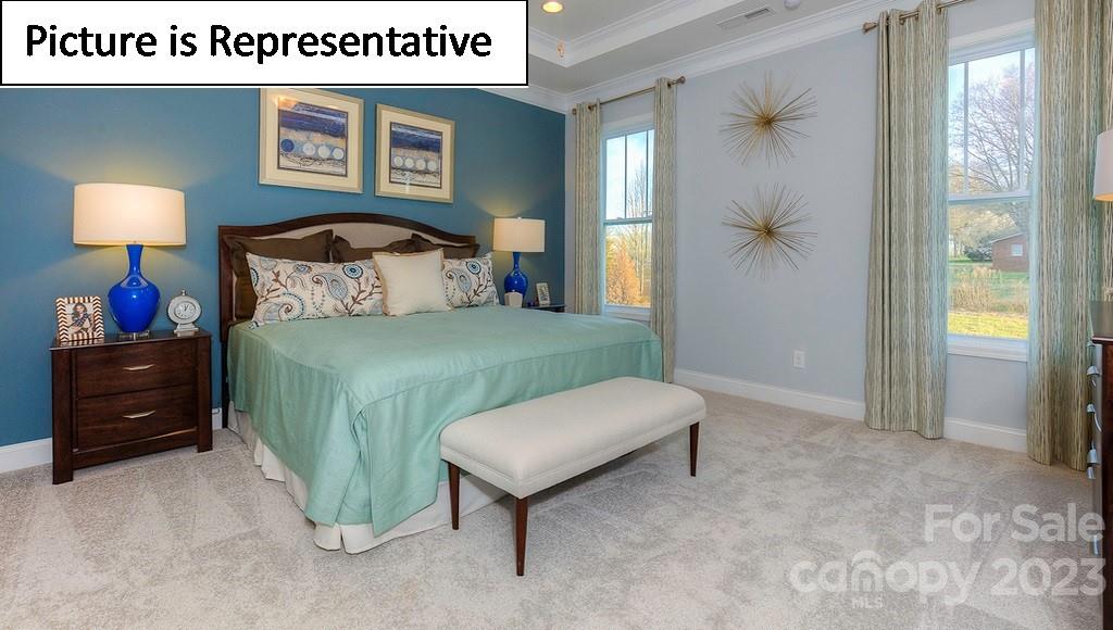 4190 Millstream Road Denver, NC 28037 - Photo 25 of 33 a bedroom with a bed and a lamp