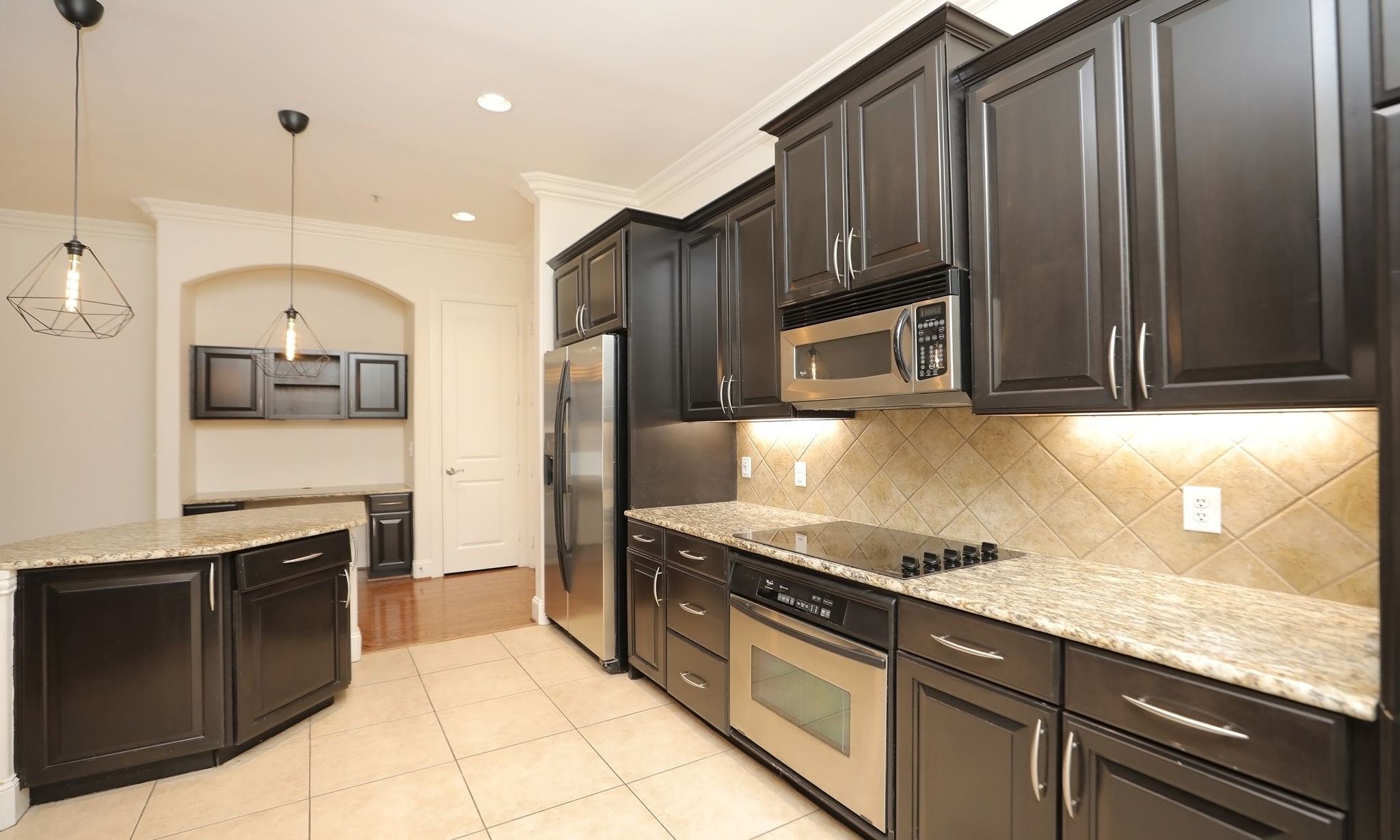 2120 Kipling Street, Unit 402 Houston, TX 77098 - Photo 13 of 30 a kitchen with stainless steel appliances granite countertop a stove a sink and a microwave
