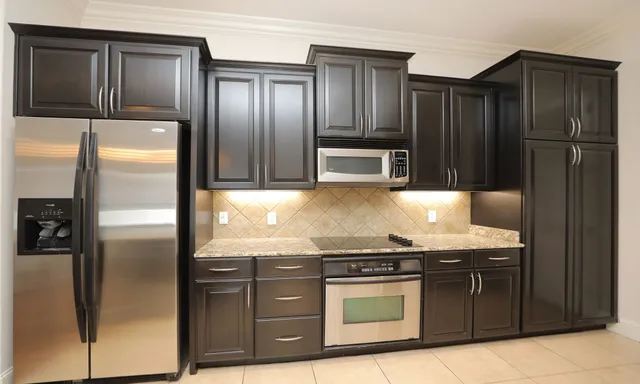 a kitchen with granite countertop stainless steel appliances and wooden cabinets