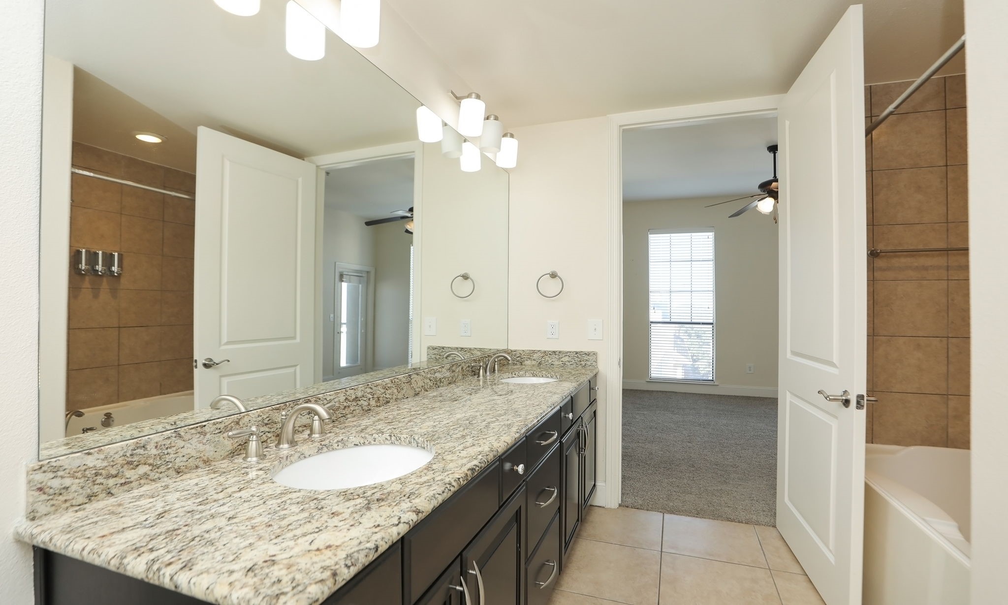 2120 Kipling Street, Unit 402 Houston, TX 77098 - Photo 25 of 30 a bathroom with a granite countertop sink and a mirror