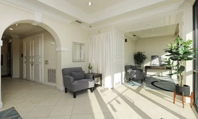 a living room with furniture and a potted plant