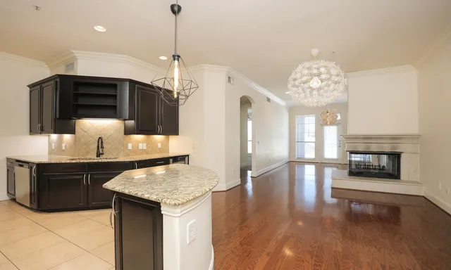 a kitchen with granite countertop a stove and a kitchen island