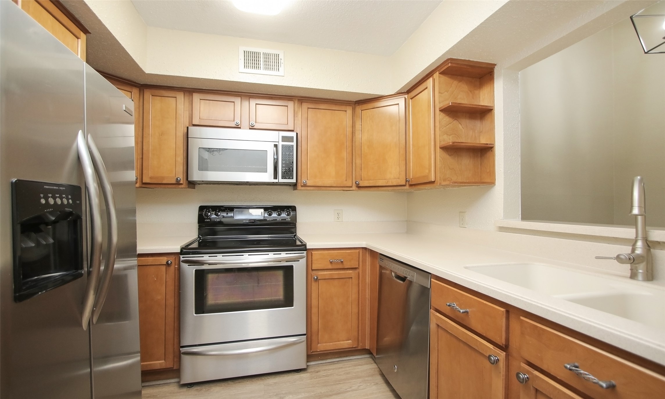 4900 Floyd Street, Unit 11 Houston, TX 77007 - Photo 13 of 37 Kitchen with Stainless Steel Appliances - Fridge included!