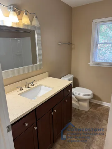 a bathroom with a sink toilet and mirror