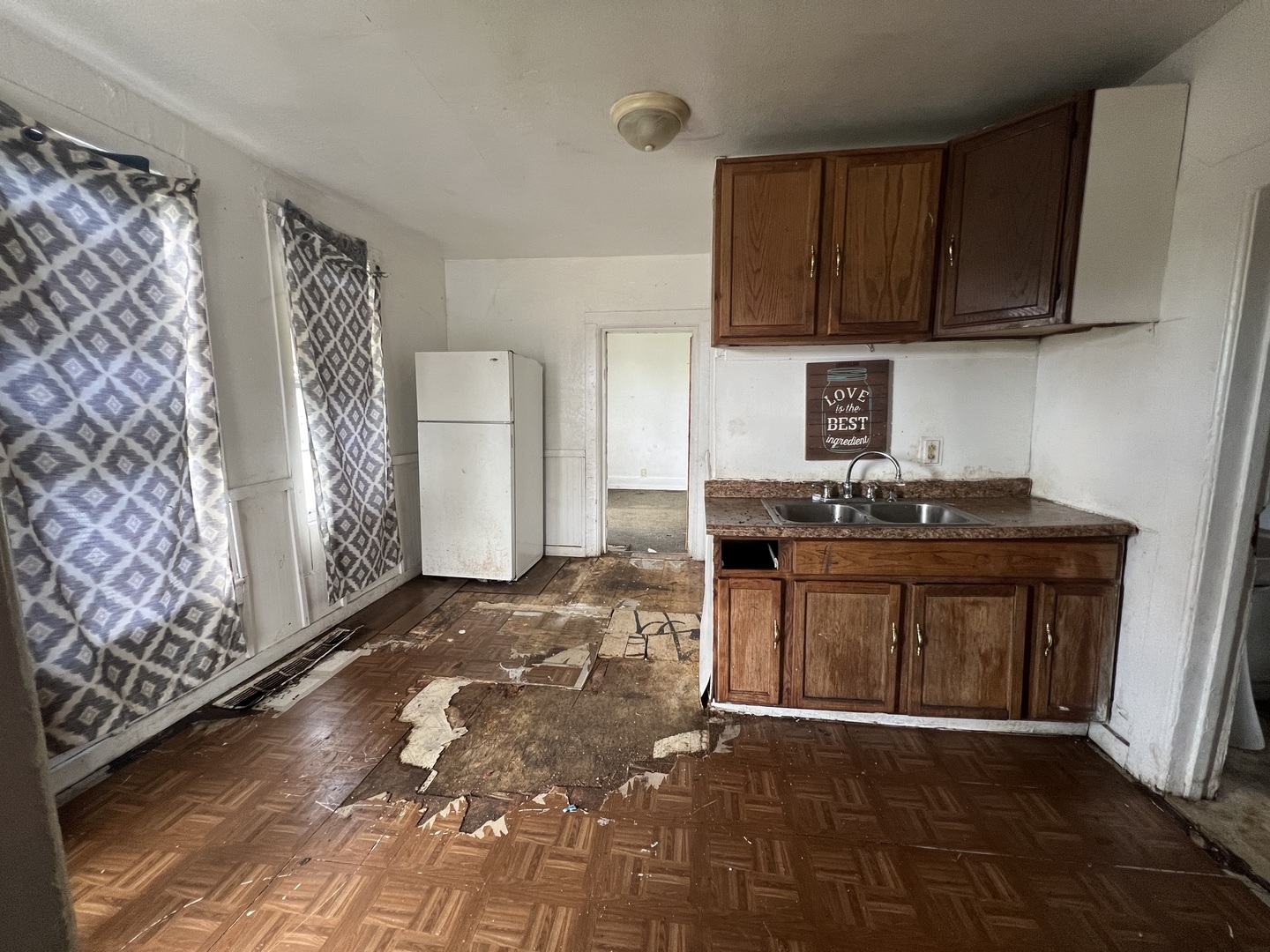 301 North West Avenue Kankakee, IL 60901 - Photo 3 of 13 a kitchen with a sink a stove and cabinets