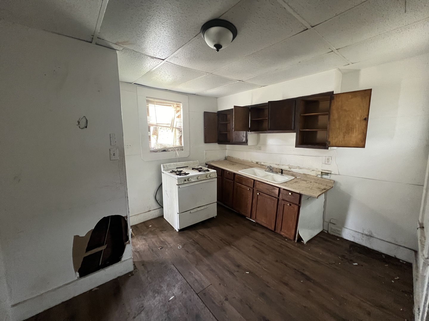301 North West Avenue Kankakee, IL 60901 - Photo 7 of 13 a large kitchen with a large window a sink and stainless steel appliances