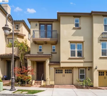 a front view of a residential apartment building with a yard