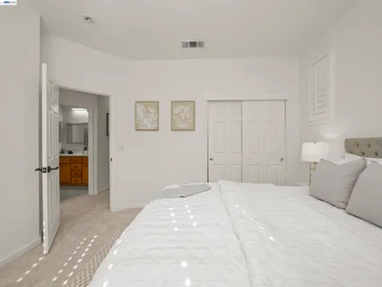 a bedroom with a bed and a view of bathroom