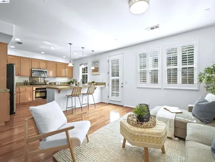 a living room with furniture kitchen and a table