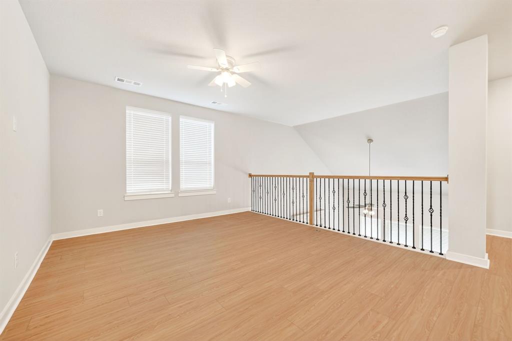 1810 Rhea Court Celina, TX 75009 - Photo 12 of 32 This versatile loft area features light wood flooring, a ceiling fan, and windows with blinds for natural light