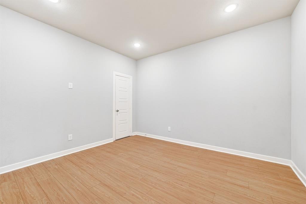 1810 Rhea Court Celina, TX 75009 - Photo 14 of 32 This room features recessed lighting, light-colored walls, and wood plank flooring, creating a versatile interior