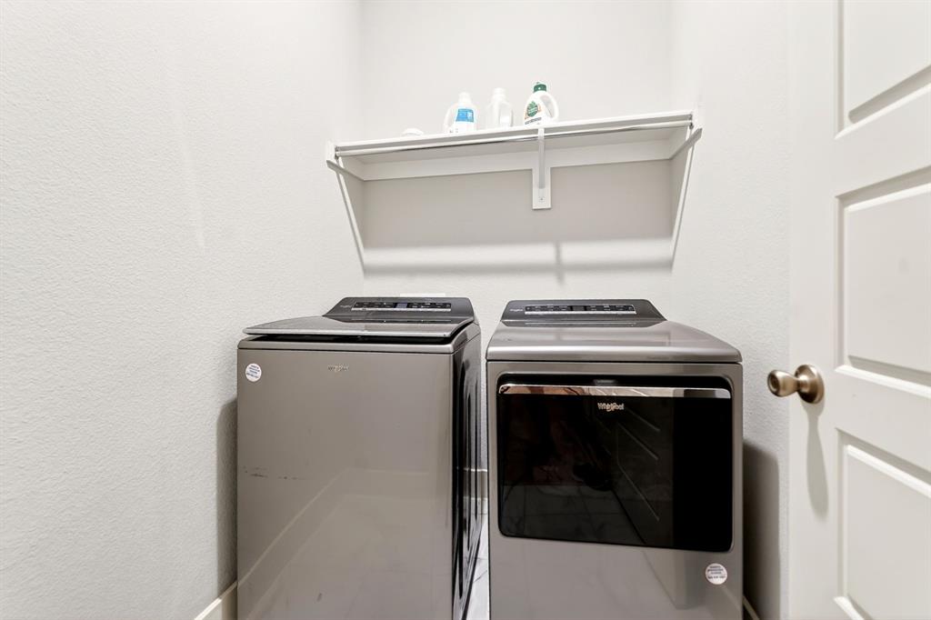 1810 Rhea Court Celina, TX 75009 - Photo 23 of 32 Laundry area with a wall-mounted shelf and white paneled door