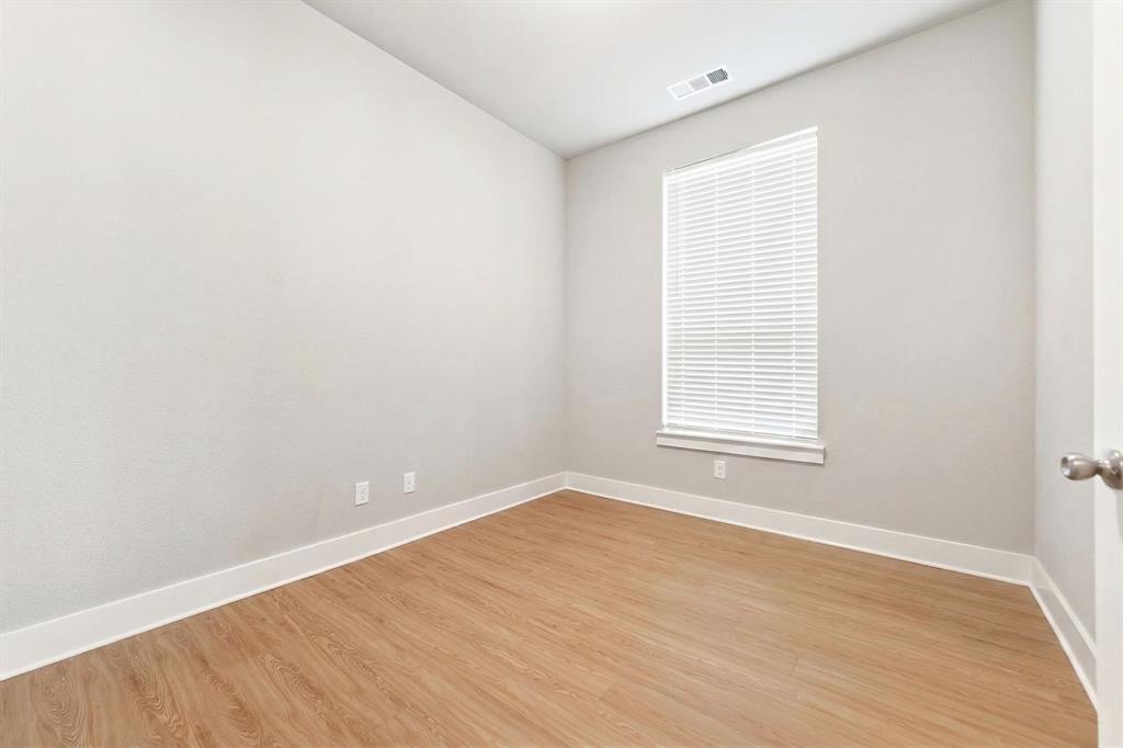 1810 Rhea Court Celina, TX 75009 - Photo 24 of 32 This room features light-colored walls, a window with blinds, and light wood-style flooring