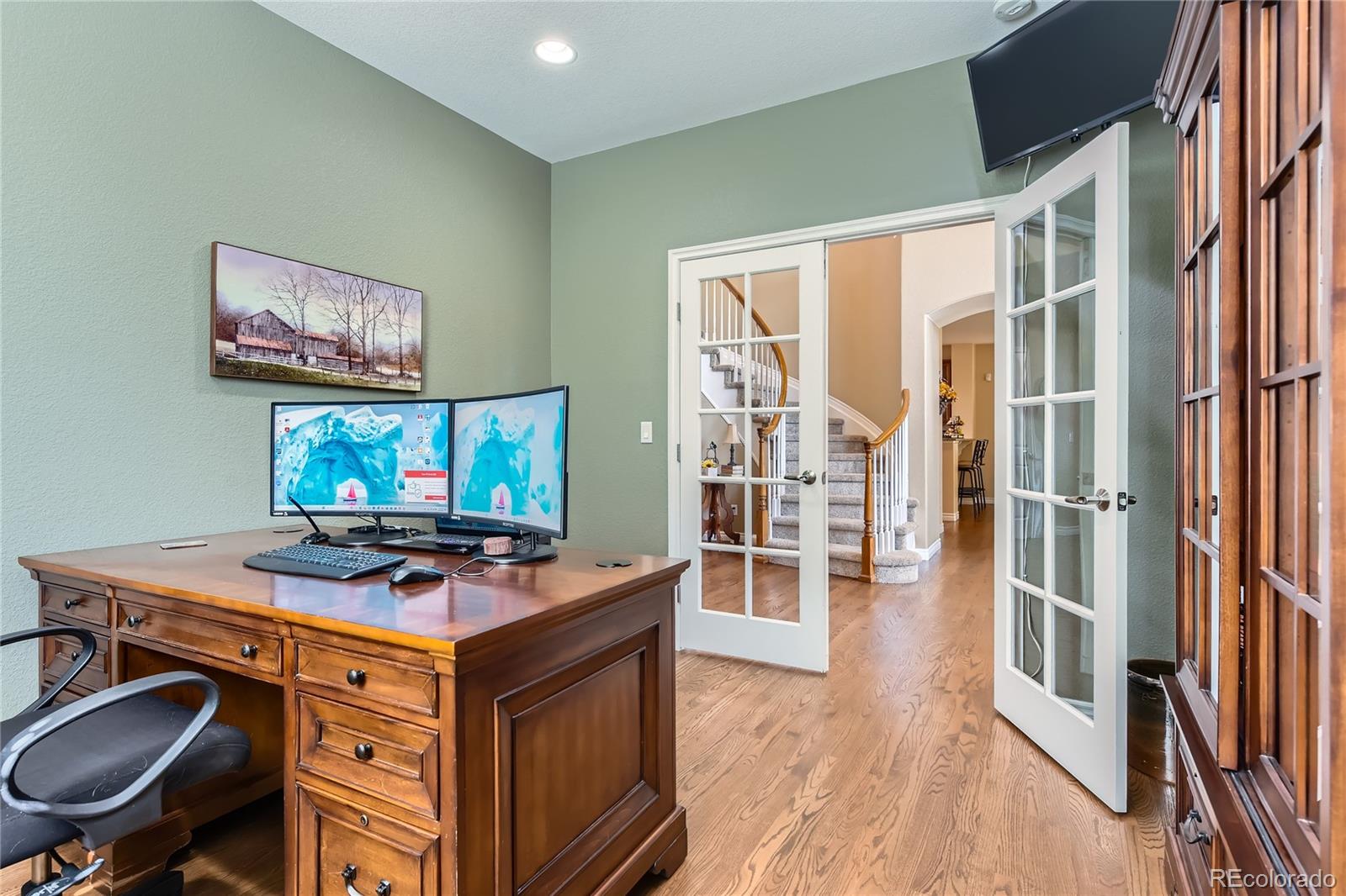 11074 Grayledge Circle Highlands Ranch, CO 80130 - Photo 13 of 47 a view of a workspace with furniture and a flat screen tv