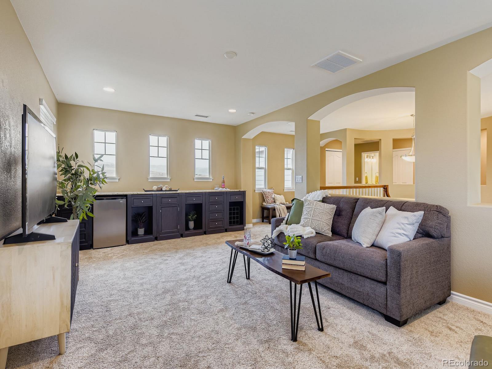 11074 Grayledge Circle Highlands Ranch, CO 80130 - Photo 14 of 47 a living room with furniture and a flat screen tv