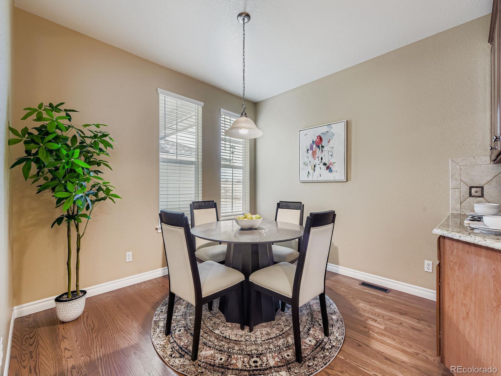 11074 Grayledge Circle Highlands Ranch, CO 80130 - Photo 18 of 47 a view of a dining room with furniture window and wooden floor