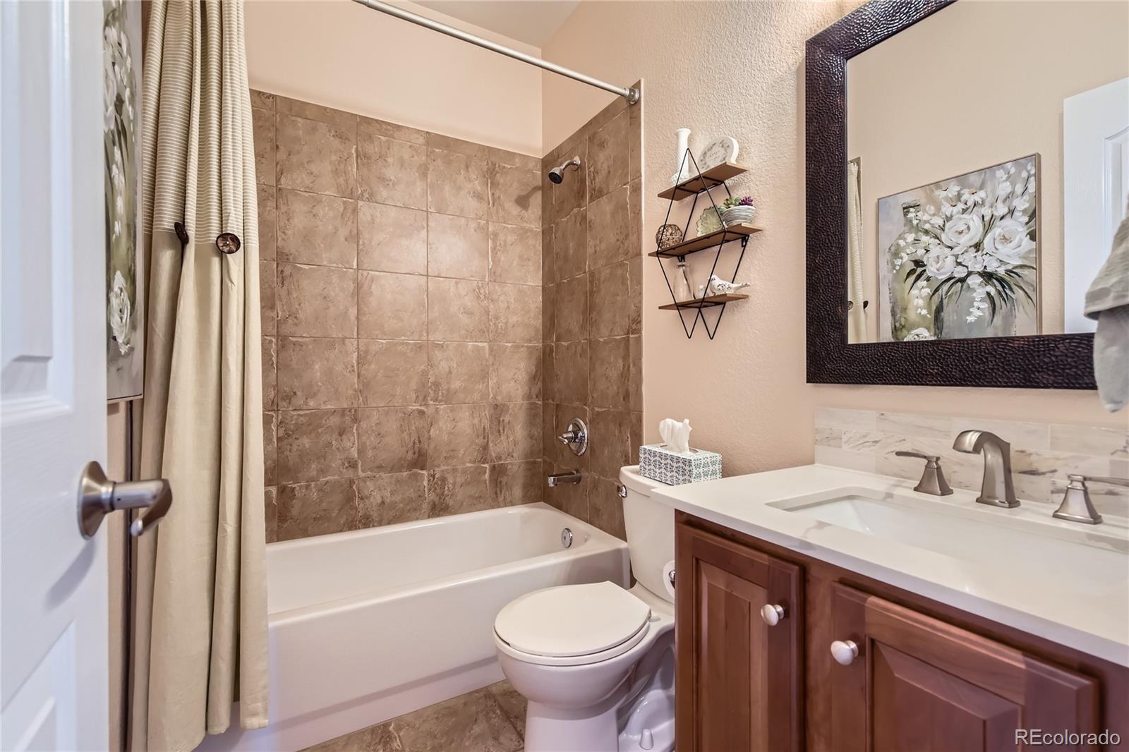 11074 Grayledge Circle Highlands Ranch, CO 80130 - Photo 23 of 47 a bathroom with a sink a toilet and a bathtub