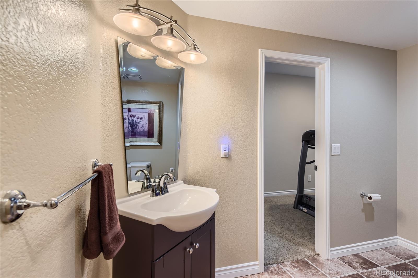 11074 Grayledge Circle Highlands Ranch, CO 80130 - Photo 34 of 47 a en suite bathroom with a sink double vanity and a mirror