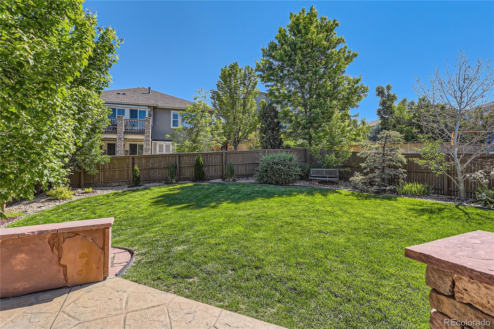 11074 Grayledge Circle Highlands Ranch, CO 80130 - Photo 41 of 47 a view of a backyard with table and chairs and plants