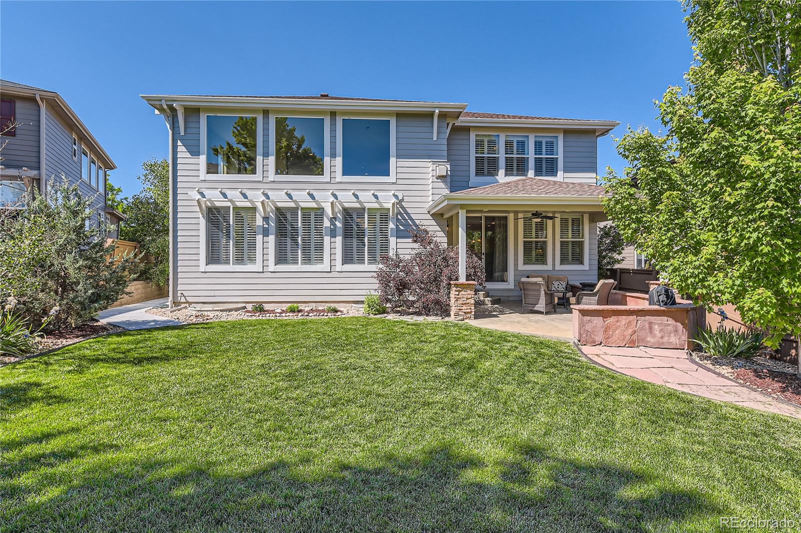 11074 Grayledge Circle Highlands Ranch, CO 80130 - Photo 42 of 47 a front view of a house with a yard table and chairs