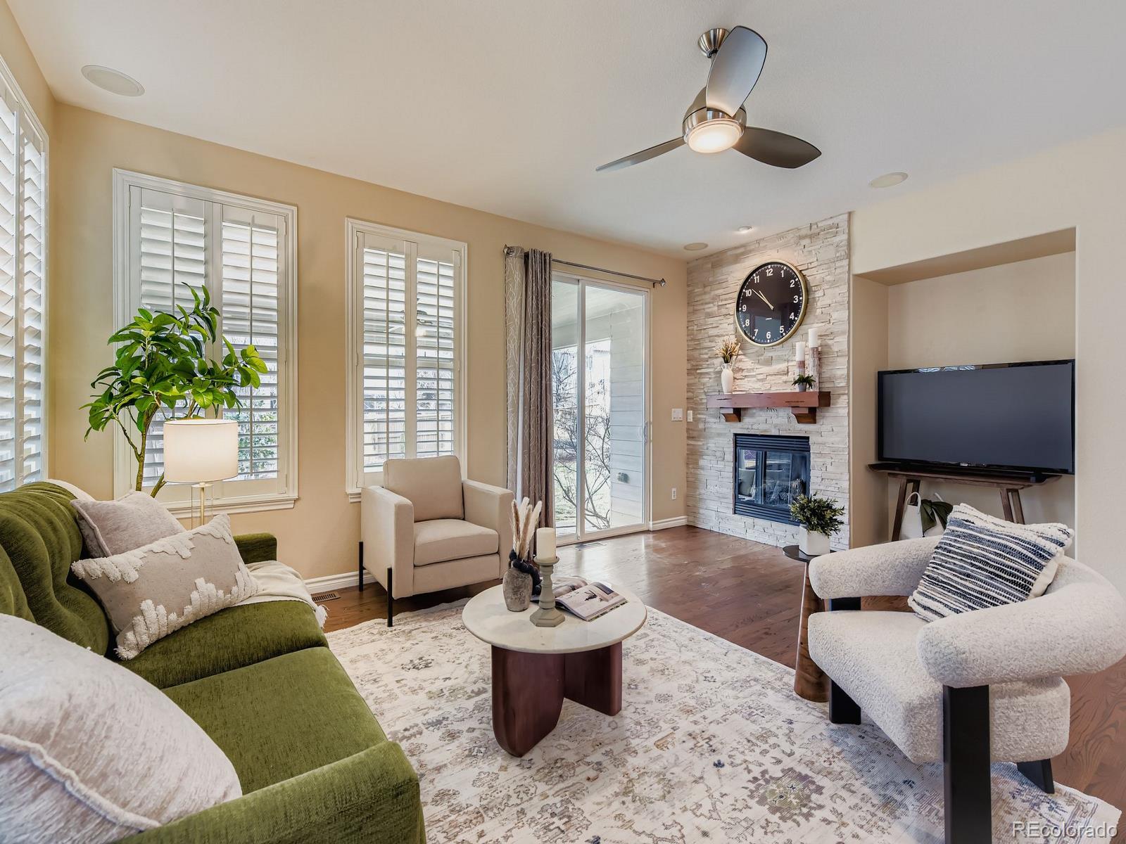 11074 Grayledge Circle Highlands Ranch, CO 80130 - Photo 10 of 47 a living room with furniture and a flat screen tv