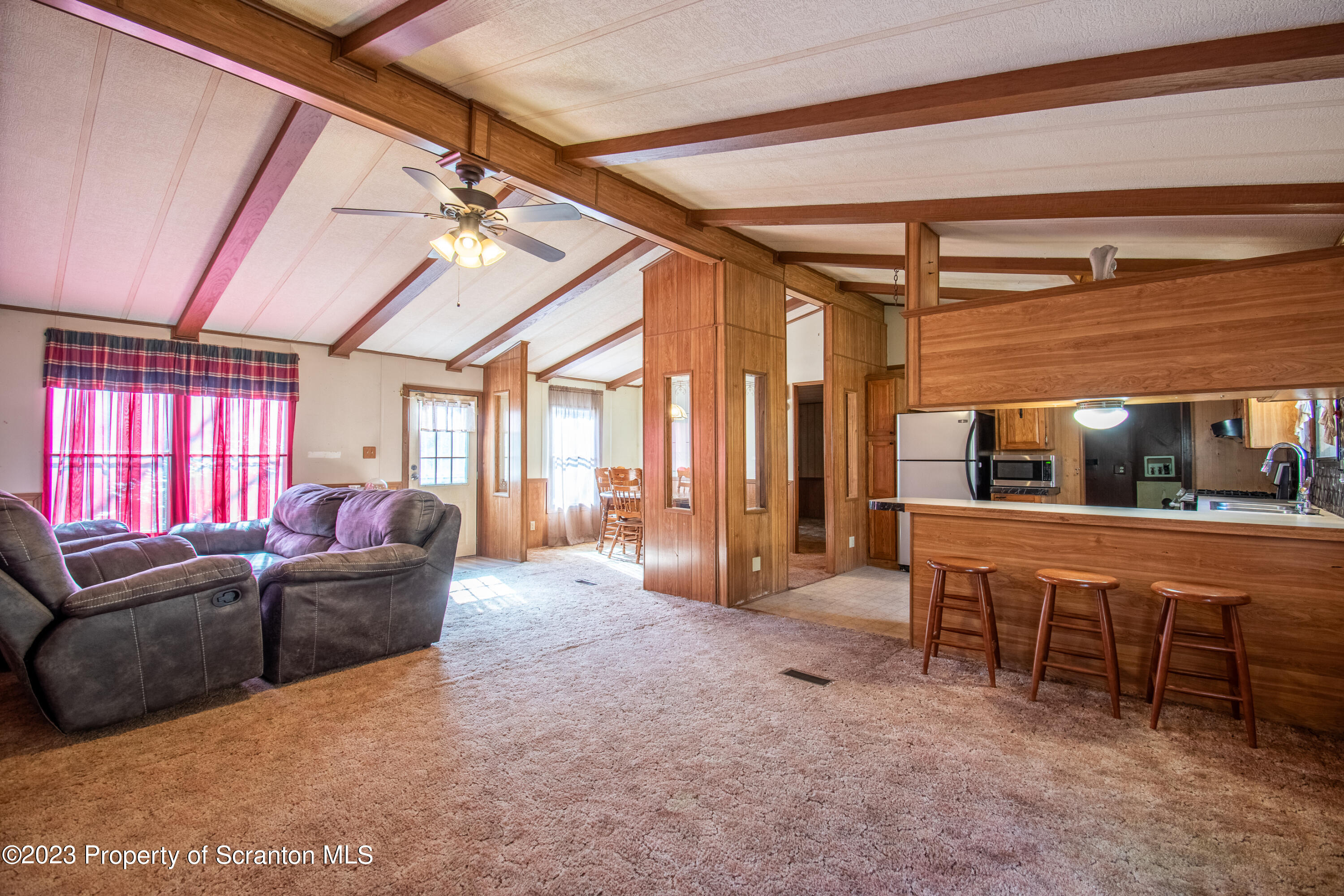 3489 Silver Creek Road Montrose, PA 18801 - Photo 24 of 35 a living room with furniture a ceiling fan and a rug