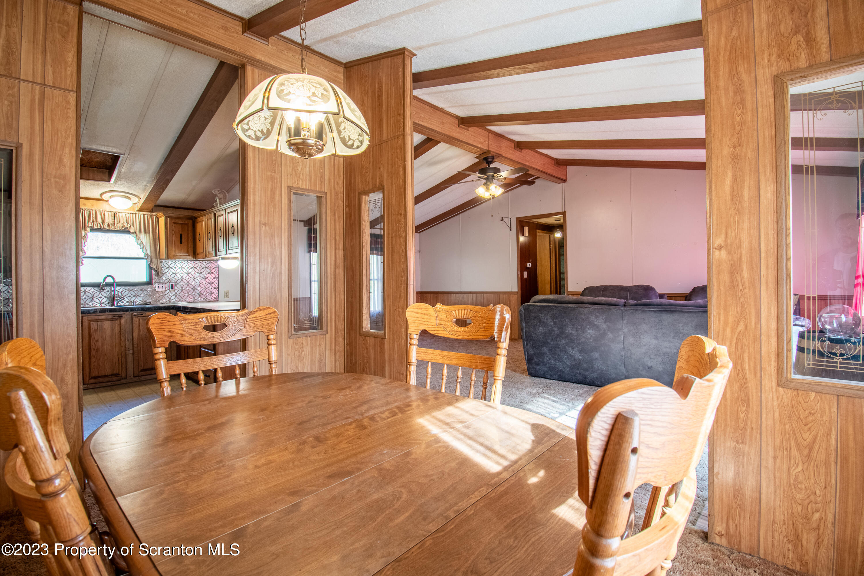 3489 Silver Creek Road Montrose, PA 18801 - Photo 27 of 35 a living room with furniture a chandelier and a dining table