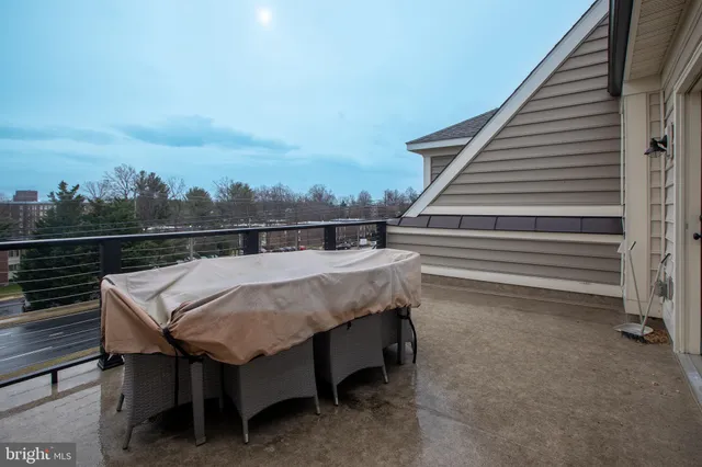 a terrace with outdoor seating and trees