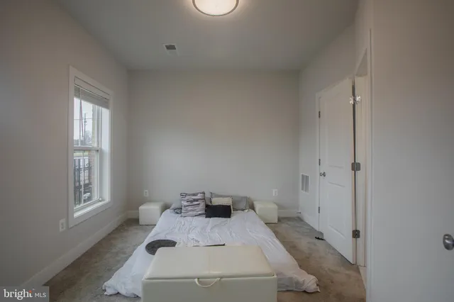 a bed room with a bed and a window