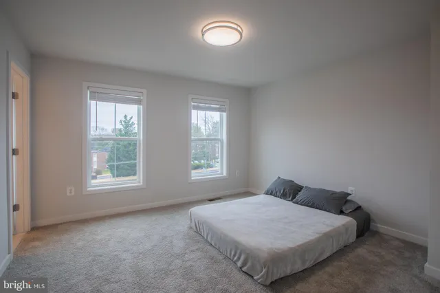 a bed sitting in a bedroom next to a window