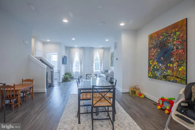 a view of a room with furniture and wooden floor