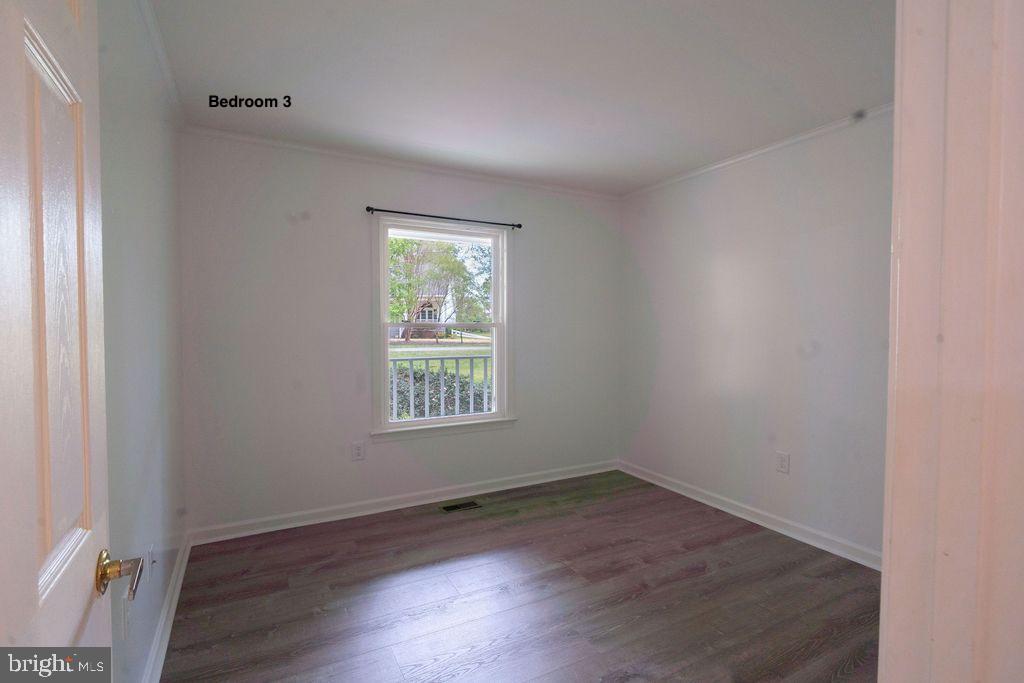 89 Club View Drive Lancaster, VA 22503 - Photo 15 of 25 an empty room with wooden floor and windows