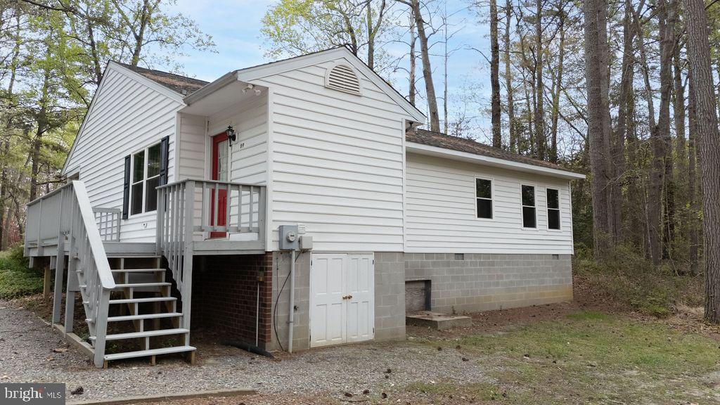 89 Club View Drive Lancaster, VA 22503 - Photo 18 of 25 a front view of a house with a yard and garage