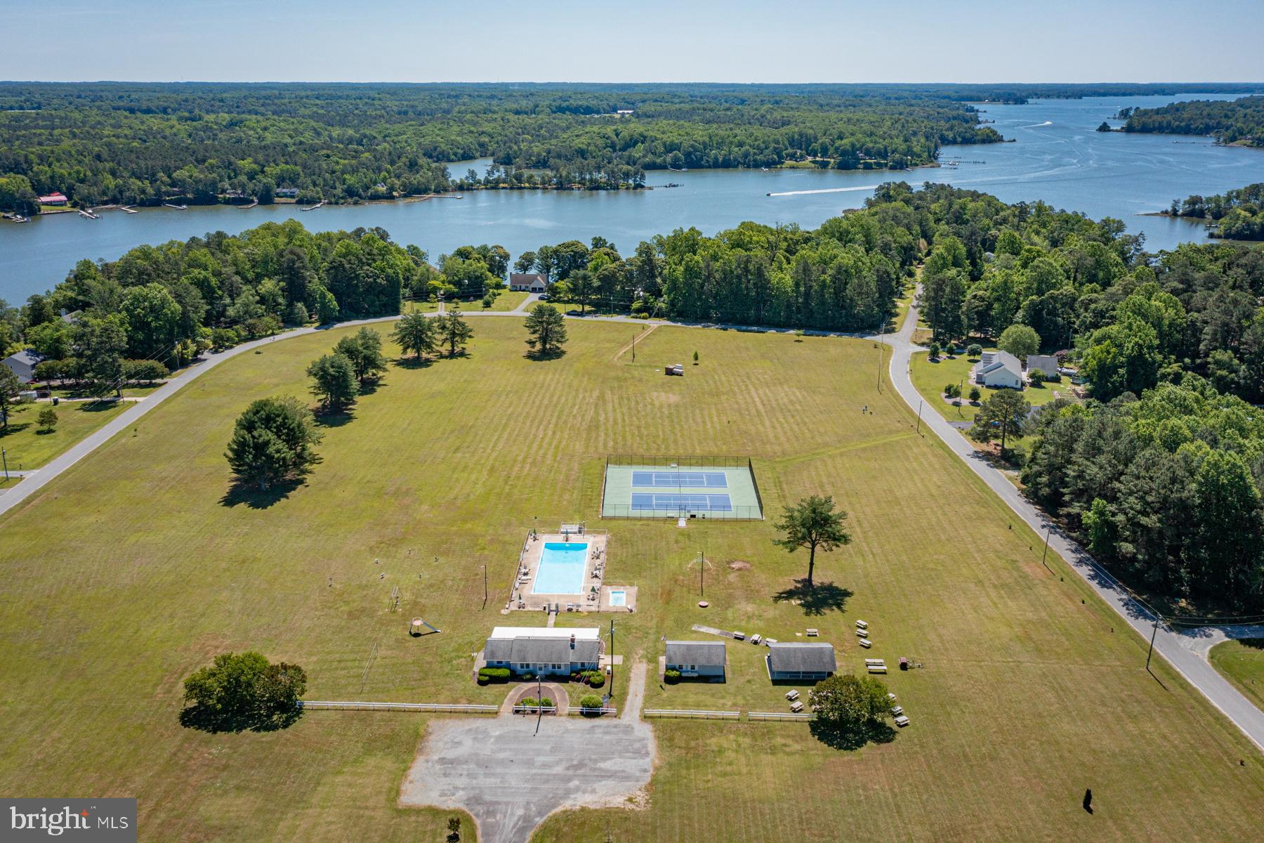 89 Club View Drive Lancaster, VA 22503 - Photo 21 of 25 a view of a lake with couches in the patio