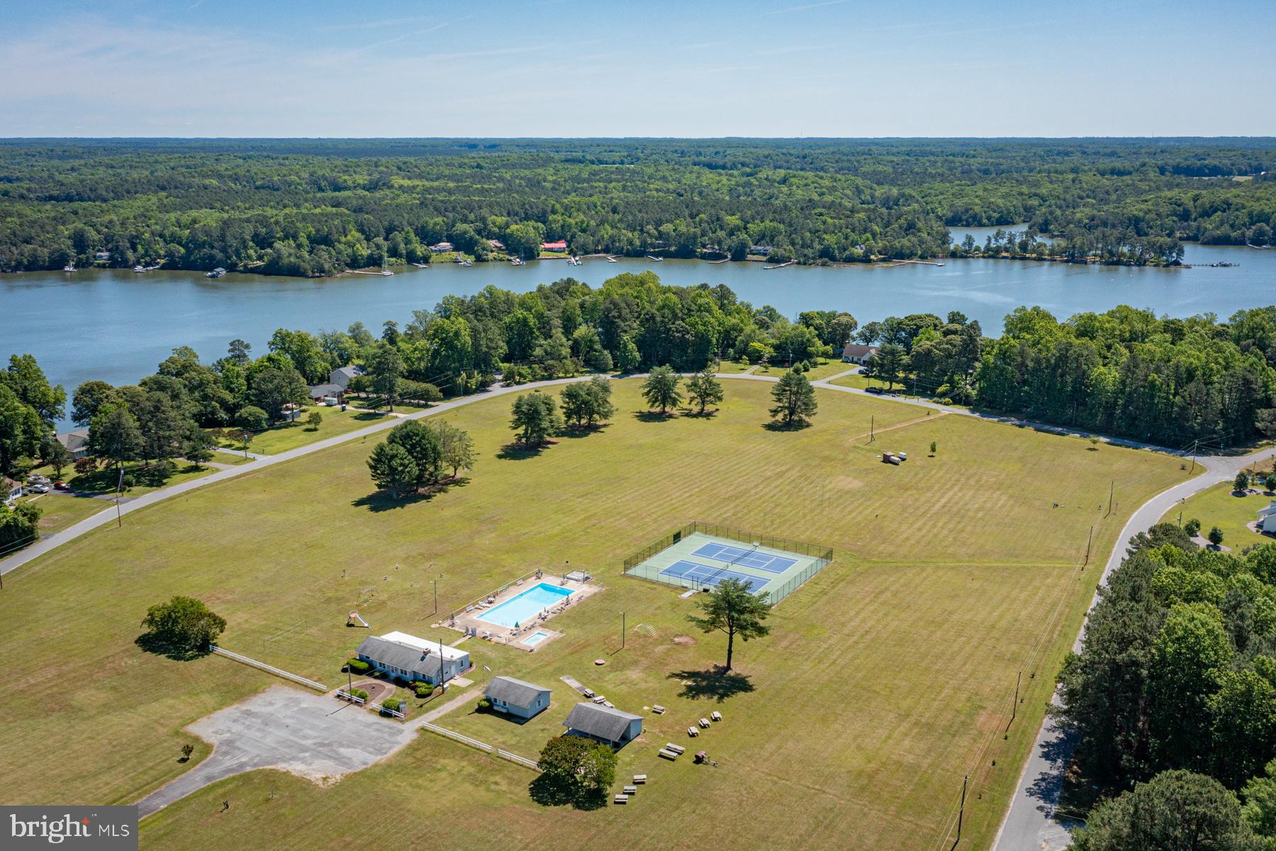 89 Club View Drive Lancaster, VA 22503 - Photo 22 of 25 an aerial view of a house with swimming pool and lake view