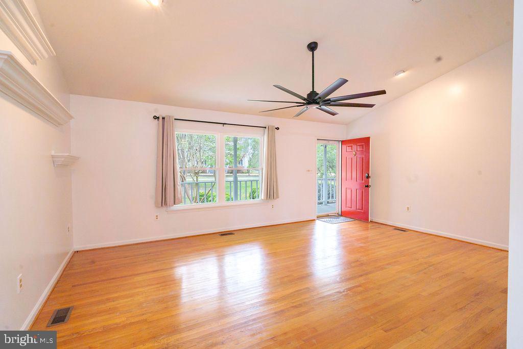 89 Club View Drive Lancaster, VA 22503 - Photo 5 of 25 a view of a livingroom with a ceiling fan and wooden floor