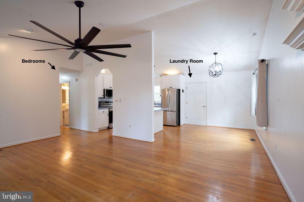 89 Club View Drive Lancaster, VA 22503 - Photo 6 of 25 a view of a livingroom with a ceiling fan wooden floor and a ceiling fan