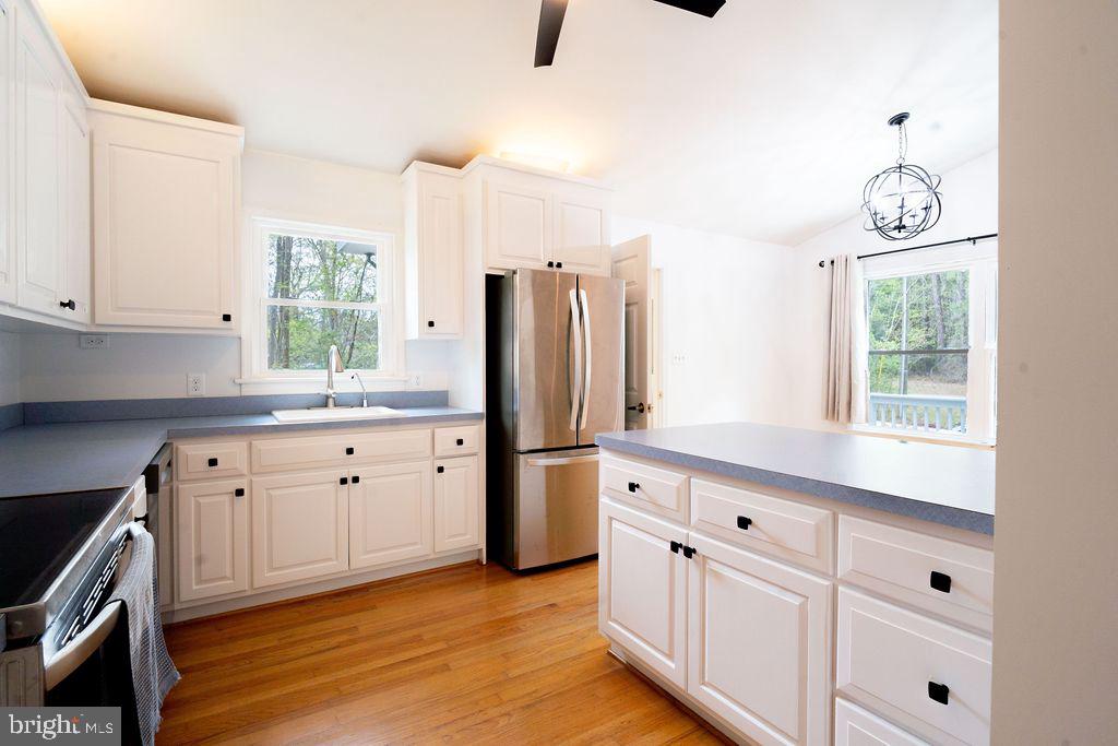 89 Club View Drive Lancaster, VA 22503 - Photo 9 of 25 a kitchen with granite countertop white cabinets and white appliances